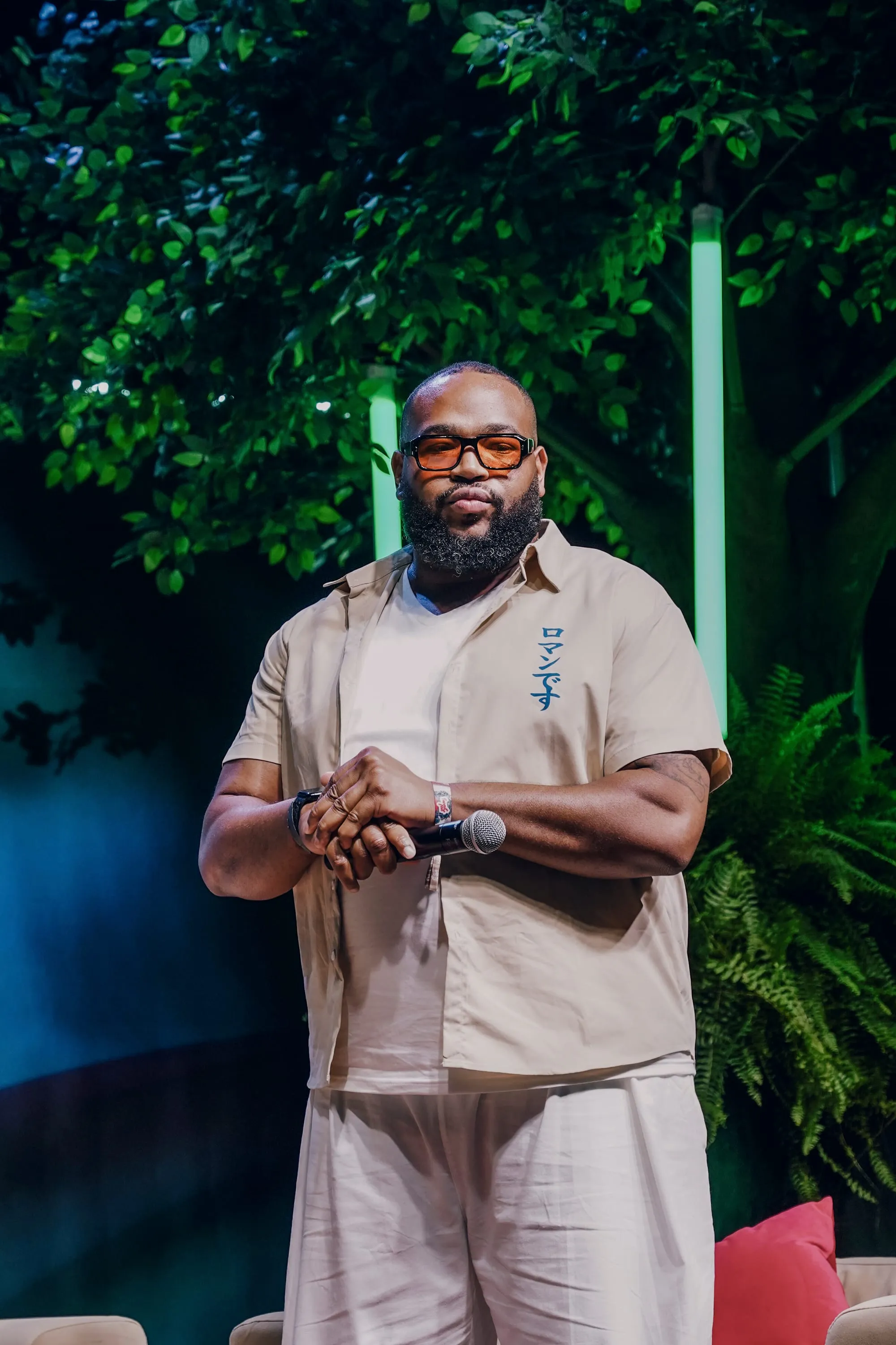 Marlon Avery speaking on a fireside-chat stage